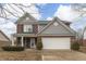 Charming two-story home featuring a brick and gray facade with an attached two-car garage at 5328 Kidwell Cir, Indianapolis, IN 46239