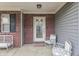 Inviting front porch featuring brick accents, seating, and a decorative glass door at 5328 Kidwell Cir, Indianapolis, IN 46239