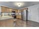 Updated kitchen featuring stainless steel appliances, wooden cabinets, and modern flooring at 5328 Kidwell Cir, Indianapolis, IN 46239