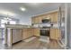 Eat-in kitchen with wood cabinets, stainless steel appliances, and modern flooring at 5328 Kidwell Cir, Indianapolis, IN 46239