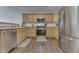 Bright kitchen with stainless steel appliances, wood cabinets, and stylish flooring at 5328 Kidwell Cir, Indianapolis, IN 46239