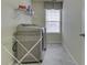 Well-lit laundry room with modern washer and dryer, shelving and laundry rack at 5328 Kidwell Cir, Indianapolis, IN 46239