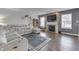 Comfortable living room featuring a fireplace, dark floors, and an oversized reclining sofa at 5328 Kidwell Cir, Indianapolis, IN 46239