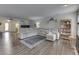 Bright living room featuring a large sectional sofa, dark floors, and neutral color palette at 5328 Kidwell Cir, Indianapolis, IN 46239