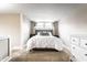 Serene bedroom featuring a plush bed with decorative pillows, neutral decor, and cozy carpet flooring at 5432 Winthrop Ave, Indianapolis, IN 46220