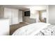 Minimalist bedroom featuring a closet, dresser, a mounted TV and a bed, offering a calm and uncluttered living space at 5432 Winthrop Ave, Indianapolis, IN 46220