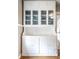 Elegant built-in cabinet with glass doors, offering ample storage and display space in the dining area at 5432 Winthrop Ave, Indianapolis, IN 46220