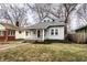 Charming gray home with a cozy front porch, mature trees, and well-maintained lawn at 5432 Winthrop Ave, Indianapolis, IN 46220