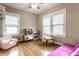 Cheerful playroom with ample natural light, hardwood floors, and a variety of play furniture for creative activities at 5432 Winthrop Ave, Indianapolis, IN 46220