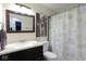 Modern bathroom with a dark vanity, gray towel, and custom shower curtain at 5443 Alcott Ln, Indianapolis, IN 46221