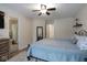 Comfortable bedroom featuring ceiling fan, ensuite bathroom and neutral paint to create a relaxing space at 5443 Alcott Ln, Indianapolis, IN 46221