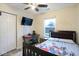 Bedroom featuring ceiling fan, desk, and vinyl floors at 5443 Alcott Ln, Indianapolis, IN 46221