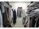 Organized walk-in closet with shelves and hanging racks to maximize storage space at 5443 Alcott Ln, Indianapolis, IN 46221