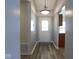 Inviting entryway with front door, hardwood floors, and view into the kitchen at 5443 Alcott Ln, Indianapolis, IN 46221