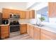 Functional kitchen with modern appliances and light wood cabinets offering a warm and inviting space at 5443 Alcott Ln, Indianapolis, IN 46221