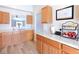 Well-lit kitchen features ample counter space, light wood cabinets, and modern flooring for a cozy cooking experience at 5443 Alcott Ln, Indianapolis, IN 46221