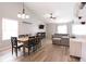 Open-concept living room and dining area, with hardwood floors and modern lighting fixtures at 5443 Alcott Ln, Indianapolis, IN 46221