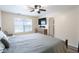 Bright main bedroom with a large window, wooden dresser, and comfortable bedding at 5443 Alcott Ln, Indianapolis, IN 46221