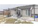 Cozy patio featuring a metal pergola over outdoor seating, grill, sliding glass door, and winter grass at 5443 Alcott Ln, Indianapolis, IN 46221