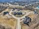 An aerial view of a Primary-planned community with large modern homes, landscaping and a lake in the distance at 580 Exmoor Dr, Carmel, IN 46032