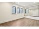 Modern basement with wood floors and a large mirror along the far wall at 580 Exmoor Dr, Carmel, IN 46032