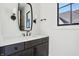 A well-lit bathroom featuring modern fixtures and a black-framed mirror and black fixtures at 580 Exmoor Dr, Carmel, IN 46032