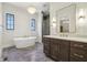 Bright bathroom featuring a soaking tub, elegant vanity, and tiled walk-in shower at 580 Exmoor Dr, Carmel, IN 46032