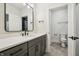 Modern bathroom featuring sleek gray vanity, white countertop, and shower at 580 Exmoor Dr, Carmel, IN 46032
