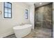 Bright bathroom featuring a soaking tub and tiled walk-in shower at 580 Exmoor Dr, Carmel, IN 46032