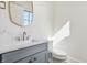 Charming powder room with a marble countertop, and a modern gold mirror at 580 Exmoor Dr, Carmel, IN 46032