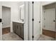 Bathroom featuring gray vanity, white countertop, and modern lighting at 580 Exmoor Dr, Carmel, IN 46032