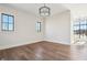 The vacant bedroom features wood floors, ample natural light, and modern ceiling light at 580 Exmoor Dr, Carmel, IN 46032