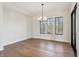 Dining room showcasing hardwood floors, natural light from multiple windows, and a stylish chandelier at 580 Exmoor Dr, Carmel, IN 46032