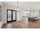 Open concept dining room features hardwood floors, modern lighting, and a kitchen island providing seating at 580 Exmoor Dr, Carmel, IN 46032