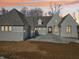 Beautiful new construction shows an elegant facade and two-car garage with a concrete driveway and professionally landscaped yard at 580 Exmoor Dr, Carmel, IN 46032