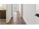 Hallway with hardwood floors, leading to a vanity and sink area, promoting an open and connected feel at 580 Exmoor Dr, Carmel, IN 46032