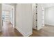 Bright hallway featuring wood floors and white trim throughout the home at 580 Exmoor Dr, Carmel, IN 46032