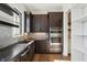 Well-lit kitchen with dark cabinetry, stainless steel appliances, and a walk-in pantry providing ample storage space at 580 Exmoor Dr, Carmel, IN 46032
