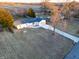 Drone shot of the home featuring the front yard, long driveway, and updated roof at 6015 Pine Hill Dr, Indianapolis, IN 46235