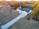 Aerial view showcases the home's spacious lot, driveway, and nearby farmland at 6015 Pine Hill Dr, Indianapolis, IN 46235