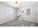 Cozy bedroom with neutral walls, soft carpet, natural light, and a ceiling fan at 6015 Pine Hill Dr, Indianapolis, IN 46235