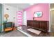 Colorful entryway featuring a pink accent wall, mid-century furnishings, and a unique front door at 6015 Pine Hill Dr, Indianapolis, IN 46235