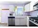 Stylish kitchen showcasing a farmhouse sink, stainless steel appliances and plant decorations at 6015 Pine Hill Dr, Indianapolis, IN 46235