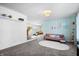 Open-concept living room with stylish furniture, a bright accent wall, and ample natural light at 6015 Pine Hill Dr, Indianapolis, IN 46235