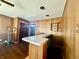Basement with wood paneling, hardwood floors, and built in bar at 6346 Shelby St, Indianapolis, IN 46227