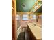 Bathroom features pink tiling, vanity with sink, and a shower with glass doors at 6346 Shelby St, Indianapolis, IN 46227