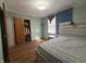 A cozy bedroom featuring hardwood floors, closet, and natural light at 6346 Shelby St, Indianapolis, IN 46227