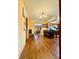 A Dining Room with hardwood floors and yellow walls leading to the kitchen area at 6346 Shelby St, Indianapolis, IN 46227