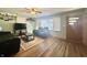 Inviting living room with hardwood floors, a ceiling fan, and comfortable black leather furniture at 6346 Shelby St, Indianapolis, IN 46227