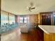 Combination living room with a wet bar, wood paneling, hardwood floors, and comfortable seating at 6346 Shelby St, Indianapolis, IN 46227